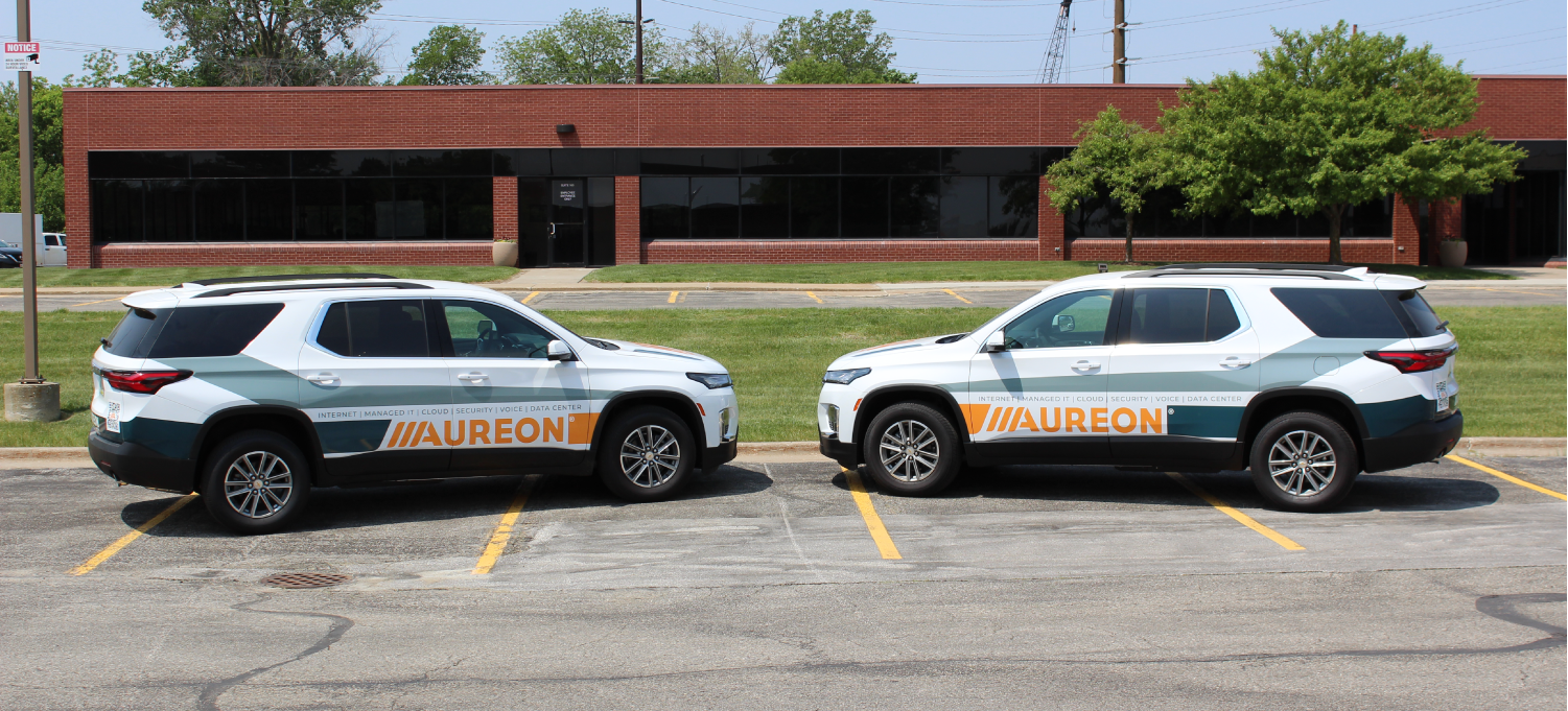 Aureon vehicle graphics — branded SUVs in the field across Iowa